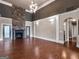 Open-concept living room with a stone fireplace, hardwood floors, and abundant natural light at 335 Canvasback Trl, Locust Grove, GA 30248