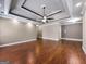 Large living room with hardwood flooring, recessed lighting, and trey ceiling at 335 Canvasback Trl, Locust Grove, GA 30248