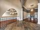 Elegant living room featuring hardwood flooring, stone accents, chandelier, and neutral color palette at 335 Canvasback Trl, Locust Grove, GA 30248