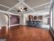 Expansive living room featuring hardwood flooring, coffered ceiling, and ample natural light at 335 Canvasback Trl, Locust Grove, GA 30248