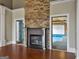 Living room featuring a stone fireplace, hardwood floors, and an indoor pool view at 335 Canvasback Trl, Locust Grove, GA 30248