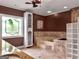 Spacious main bathroom with garden tub, stained-glass window and vanity cabinet at 335 Canvasback Trl, Locust Grove, GA 30248