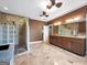 Main bathroom with a glass block shower, double vanity, and tile floors at 335 Canvasback Trl, Locust Grove, GA 30248