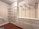 Walk-in closet is outfitted with extensive metal shelving and drawers to maximize storage space at 335 Canvasback Trl, Locust Grove, GA 30248