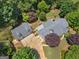 An aerial view showcasing the home, detached garage, driveway, and surrounding lush greenery at 135 Acorn Dr, Mcdonough, GA 30253