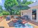 Back deck featuring an outdoor dining area with shade umbrella and benches at 135 Acorn Dr, Mcdonough, GA 30253