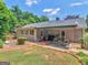 Expansive backyard featuring an outdoor seating area, mature trees, and landscaping at 135 Acorn Dr, Mcdonough, GA 30253