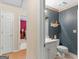 Half-bathroom with a pedestal sink and decorative floral wallpaper at 135 Acorn Dr, Mcdonough, GA 30253