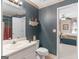 Downstairs bathroom with floral wallpaper and white fixtures at 135 Acorn Dr, Mcdonough, GA 30253