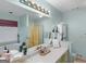 Bright bathroom vanity area with a large mirror, tub, and glass-door shower at 135 Acorn Dr, Mcdonough, GA 30253