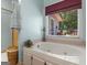 Corner bathtub by a window offering a view of the home's exterior at 135 Acorn Dr, Mcdonough, GA 30253