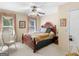Spacious bedroom with a ceiling fan, a large bed, and ample natural light at 135 Acorn Dr, Mcdonough, GA 30253