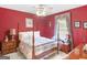 A bedroom with red walls, and a four poster bed at 135 Acorn Dr, Mcdonough, GA 30253