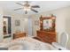 Bedroom showcasing an ornate, carved wooden bed, a ceiling fan and two windows at 135 Acorn Dr, Mcdonough, GA 30253