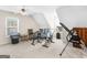 Cozy bonus room with vaulted ceilings, plush carpet, exercise equipment, and bright, natural light from windows at 135 Acorn Dr, Mcdonough, GA 30253