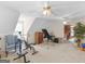 Bright bonus room featuring ample natural light, carpeted floors, and multiple ceiling fans for added comfort at 135 Acorn Dr, Mcdonough, GA 30253