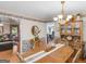 A traditionally styled dining room with hardwood floors and an open view to other living spaces at 135 Acorn Dr, Mcdonough, GA 30253
