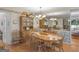 A large dining room with traditional décor, including wood table and chairs, hardwood floors, and a china cabinet at 135 Acorn Dr, Mcdonough, GA 30253