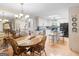 Large dining room with hardwood floors, wooden table and chairs, and an open view to the kitchen at 135 Acorn Dr, Mcdonough, GA 30253