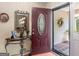 A welcoming foyer featuring a decorative table, mirror, and an inviting front door at 135 Acorn Dr, Mcdonough, GA 30253