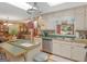 Traditional kitchen featuring white cabinets, stainless steel appliances, and a kitchen island with a hanging pot rack at 135 Acorn Dr, Mcdonough, GA 30253