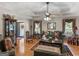 Well-lit living room with hardwood floors, comfortable seating, and a decorative fireplace at 135 Acorn Dr, Mcdonough, GA 30253