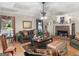 Comfortable living room with a brick fireplace, hardwood floors, and large windows, perfect for relaxing at 135 Acorn Dr, Mcdonough, GA 30253