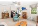 Cozy living room with large windows, a ceiling fan, comfortable seating, and unique decor at 135 Acorn Dr, Mcdonough, GA 30253
