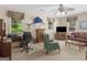 Spacious living room features a ceiling fan, a decorative marlin, and natural light from large windows at 135 Acorn Dr, Mcdonough, GA 30253