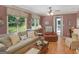 Inviting living room with large windows, hardwood floors, and comfortable seating. Perfect for relaxation at 135 Acorn Dr, Mcdonough, GA 30253