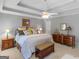 Main bedroom featuring tray ceiling, ceiling fan, and traditional decor at 135 Acorn Dr, Mcdonough, GA 30253