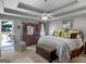 Spacious main bedroom featuring tray ceilings, a ceiling fan, and an adjacent outdoor patio at 135 Acorn Dr, Mcdonough, GA 30253