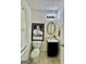 Charming bathroom with black vanity, decorative mirror, and a framed Marilyn Monroe poster at 105 Avonwood Cir, Locust Grove, GA 30248