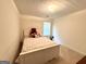 Cozy bedroom featuring a white bed frame with a floral comforter and neutral walls at 105 Avonwood Cir, Locust Grove, GA 30248