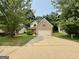 Traditional brick-accented home featuring an attached two-car garage and a well-manicured front lawn at 105 Avonwood Cir, Locust Grove, GA 30248