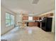 Eat-in kitchen features ample countertops, black appliances, and a separate dining area with an elegant chandelier at 105 Avonwood Cir, Locust Grove, GA 30248