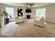 Bright living room with neutral carpet, fireplace, ceiling fan, and two large windows offering ample natural light at 105 Avonwood Cir, Locust Grove, GA 30248
