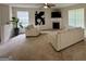 Bright living room with neutral carpet, fireplace, ceiling fan, and two large windows offering ample natural light at 105 Avonwood Cir, Locust Grove, GA 30248