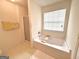 Bright main bathroom featuring a soaking tub with jets and a separate glass-enclosed shower at 105 Avonwood Cir, Locust Grove, GA 30248