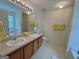 Main bathroom features double sinks, updated lighting, and a large vanity area, and separate tub and shower at 105 Avonwood Cir, Locust Grove, GA 30248
