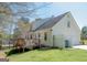 Exterior of home with a wooden deck, grassy yard and a view of the upper floor windows at 500 Hayfield Ct, Locust Grove, GA 30248