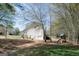 Spacious backyard with a play set, surrounded by lush greenery, and a white two-story home at 500 Hayfield Ct, Locust Grove, GA 30248