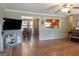Open-concept living room with hardwood floors, seamlessly connecting to the dining area and kitchen at 500 Hayfield Ct, Locust Grove, GA 30248