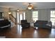 Comfortable living room featuring hardwood floors, neutral paint, and a cozy seating arrangement at 500 Hayfield Ct, Locust Grove, GA 30248