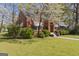 Attractive brick home featuring a well-maintained lawn and mature landscaping in a quiet setting at 109 Stockbridge Rd, Jonesboro, GA 30236