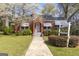 Charming brick home with a well-manicured lawn and beautiful flowering tree in the front yard at 109 Stockbridge Rd, Jonesboro, GA 30236