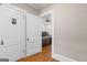 Hallway featuring doors and hardwood floors, giving a glimpse into a nearby office at 109 Stockbridge Rd, Jonesboro, GA 30236