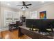 Office features hardwood floors, a ceiling fan, and abundant natural light through bright windows at 109 Stockbridge Rd, Jonesboro, GA 30236