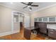 Office space with wooden floors, ceiling fan, natural light, and custom built-ins at 109 Stockbridge Rd, Jonesboro, GA 30236