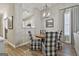 Cozy dining area with view into the kitchen, a chandelier, and stylish patterned chairs, offering a welcoming space at 1025 Pinehurst Dr, Peachtree City, GA 30269